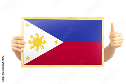 Hands holding a frame with Philippines flag, celebration or victory concept, approvement or success  photo