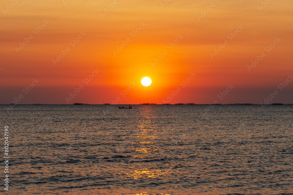 Sunset over the sea background. Big sun over the sea with beautiful natural light at sunset or sunrise. Sunset over the sea background. Big sun over the sea with beautiful natural light at sunset or sunrise.
