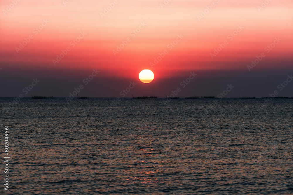 Sunset over the sea background. Big sun over the sea with beautiful natural light at sunset or sunrise. Sunset over the sea background. Big sun over the sea with beautiful natural light at sunset or sunrise.
