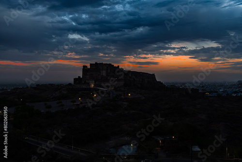 backlit shot of ancient historical fort with dramatic sunset sky at dusk from flat angle