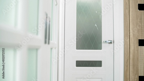 White interior door. Beautiful white door in the interior of a door sales salon. Door salon. White door.