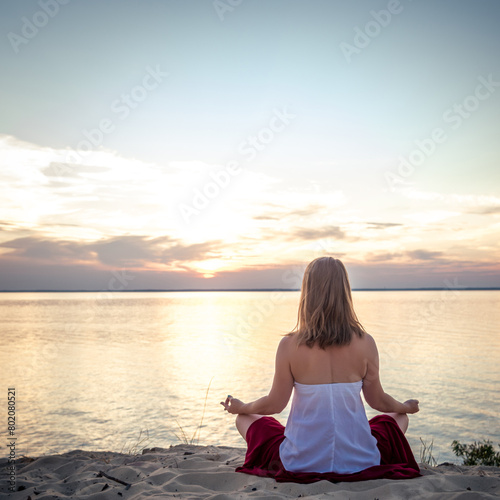 Woman meditating at the sea
