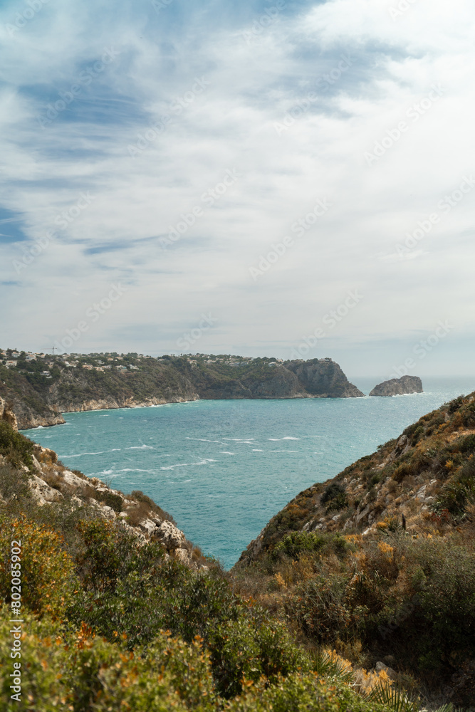Panoramic view, cliffs and Mediterranean sea on a cloudy morning day, in Jávea, Alicante (Spain).