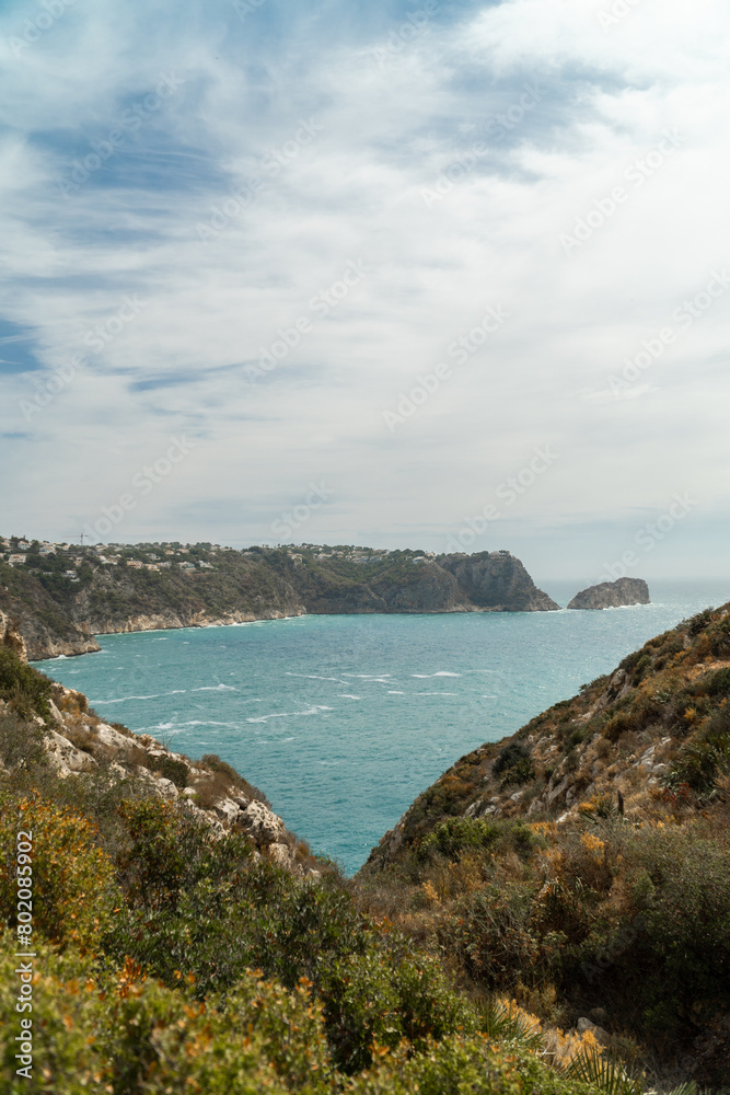 Panoramic view, cliffs and Mediterranean sea on a cloudy morning day, in Jávea, Alicante (Spain). Panoramic view, cliffs and Mediterranean sea on a cloudy morning day, in Jávea, Alicante (Spain).