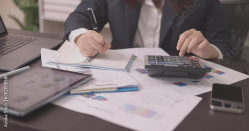 The accountant meticulously analyzes the financial document, scrutinizing every graph and chart to assess investment growth and ensure accurate accounting practices in finance. photo