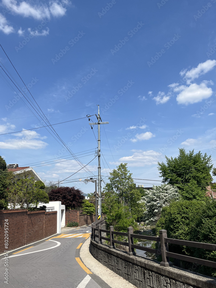 A neighborhood street on a nice day.
A neighborhood street on a nice day.