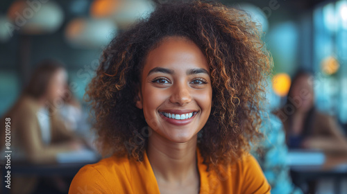 Successful afro american business woman 20 - 25 years old. Portrait smiling woman looking at camera. Office worker. Happy girl standing in creative space. © A Stock Studio