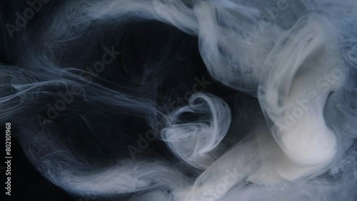 Swirling smoke creates captivating patterns under subtle lighting. (ID: 802101968)