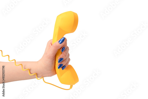 Yellow handset in woman hand isolated on white. Copy space. © Nikolay