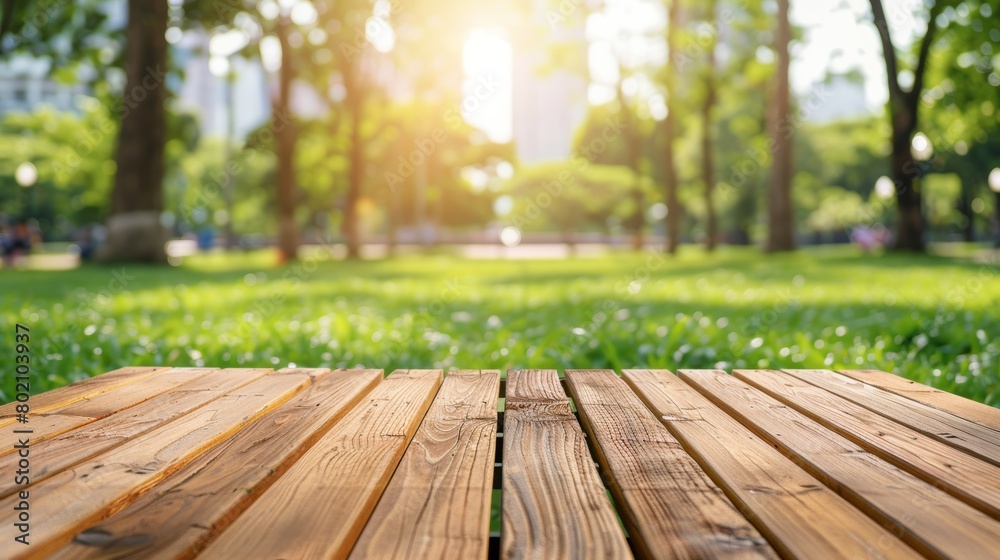 A wooden table in focus with a blurred, sunlit park background, depicting a serene, outdoor setting. A wooden table in focus with a blurred, sunlit park background, depicting a serene, outdoor setting.