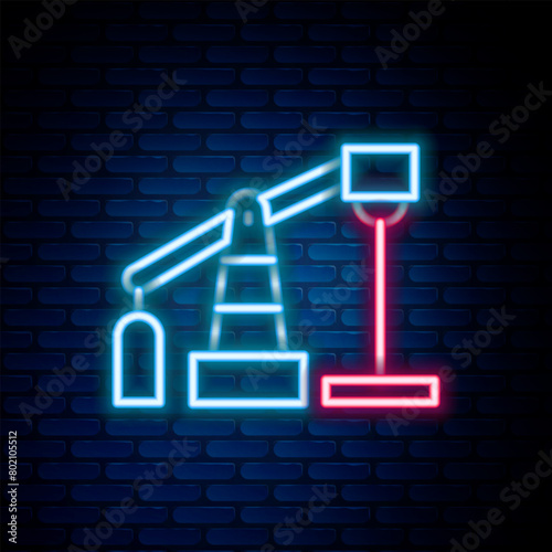 Glowing neon line Oil pump or pump jack icon isolated on brick wall background. Oil rig. Colorful outline concept. Vector