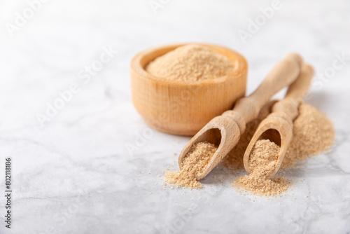 Cinnamon sugar on a texture background. Homemade cinnamon sugar in a bowl on background. Brown sugar. Spice mixture for drinks and baking. Place for text. Copy space.