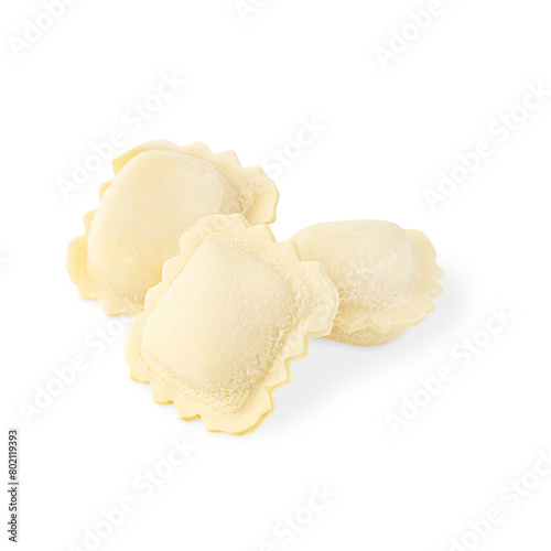 Three uncooked raw frozen traditional homemade italian ravioli pasta stuffed with ricotta cheese of square shape isolated on white background used as ingredient for mediterranean healthy tasty lunch