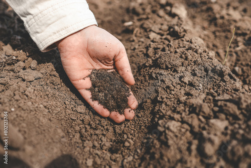 Fingers clutching soil, a gesture of connection to earth
