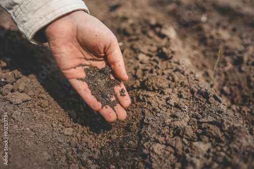 Fingers clutching soil, a gesture of connection to earth