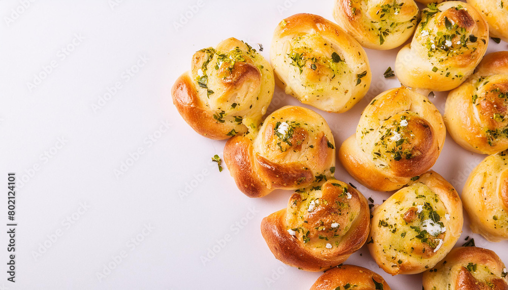 Fresh buns with garlic and herbs on white table. Tasty food. Homemade bakery. Baked goods. Top view. Fresh buns with garlic and herbs on white table. Tasty food. Homemade bakery. Baked goods. Top view.