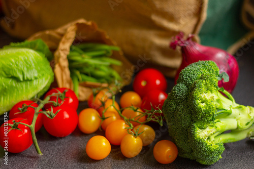 close up shopping bag with vegetables in kitchen table, healthy food background.