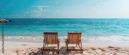 Two beach chairs are on the sand, facing the ocean © Synthetica
