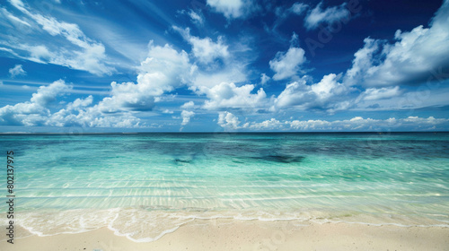 A beautiful blue ocean with a few clouds in the sky