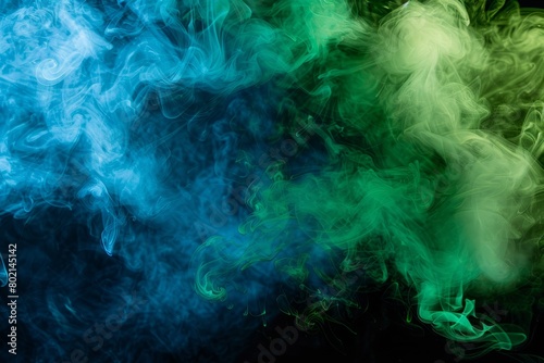 Colorful green and blue smoke gracefully billows against a black backdrop, accentuated by soft lighting