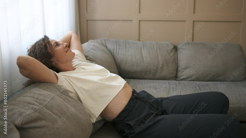 Relaxed young mixed race woman enjoying rest on comfortable sofa at home Relaxed young mixed race woman enjoying rest on comfortable sofa at home