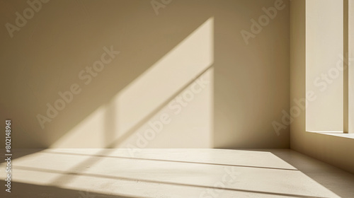 A room with a window and a wall. The room is empty and the sunlight is shining on the wall