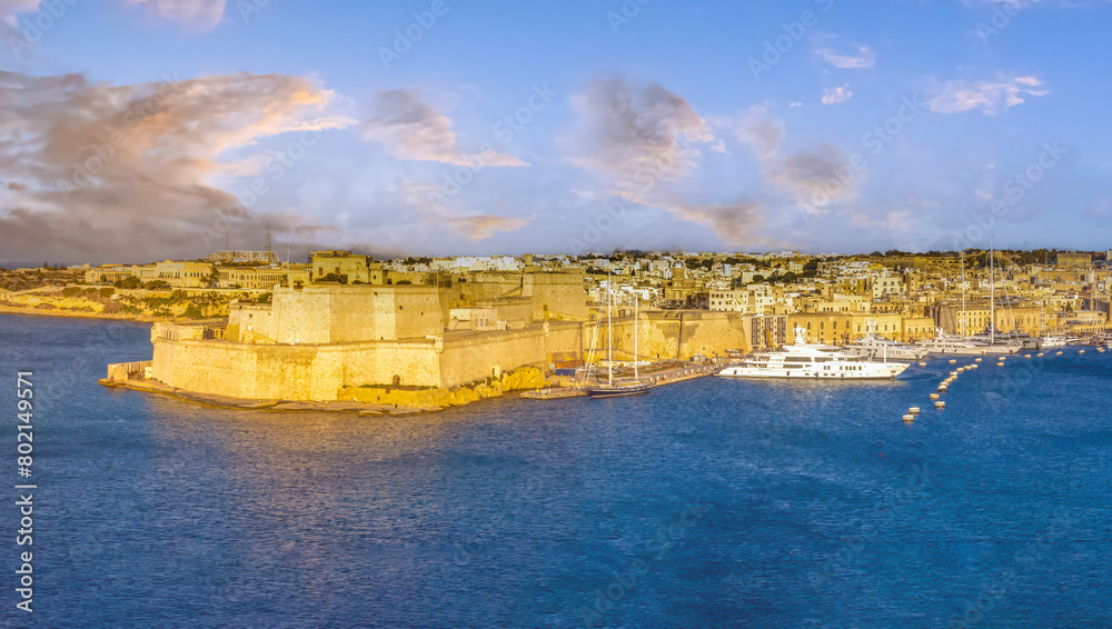 Sunset view of the fortified sea front of Birgu (Cospicua), Grand Harbour, across from the old town of Valletta (Il-Belt), Malta