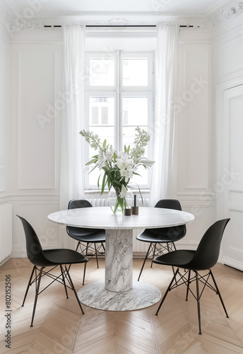 A round dining table with black chairs and white marble, in an elegant Parisian apartment with parquet flooring. The room features large windows and soft natural light, creating a bright atmosphere. © gamespirit