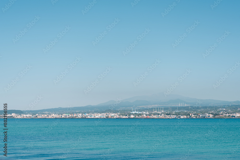 Hallim-eup seaside village and volcanic oreum view from Biyangdo Island in Jeju island, Korea