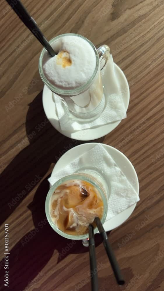 waiter serves two lattes, hot and cold, comparing the two flavors Ice latte and Hot late