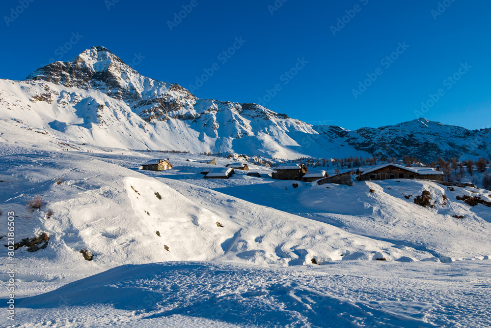 snowy alpine landscape under the peak of Pizzo Scalino