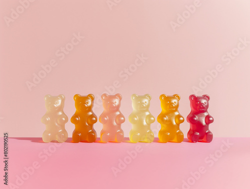 Multicolored gummy bears isolated on a pink background. Aesthetic macro photography