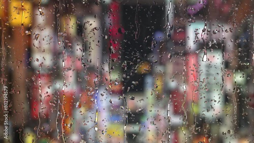 ガラス越し繁華街と雨のループ素材 photo