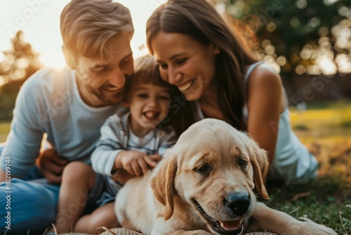 Happy young family Having fun Playing with Cute Little puppy In the Backyard. Sunny Summer Day in Idyllic Suburban House © Yulia