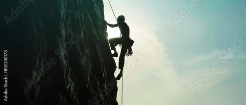 A rock climbers silhouette against the rugged cliff face highlights a journey of strength and determination, Sharpen closeup highdetail realistic concept good mood tone
