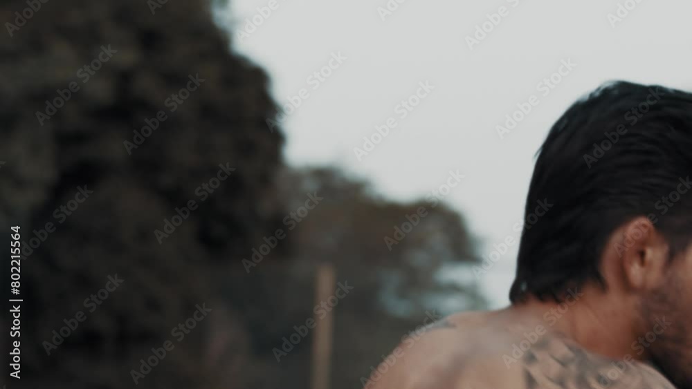 Athlete punching the air shirtless outdoor