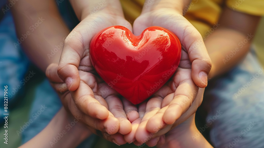 Family hands holding red heart, health insurance concept Family hands holding red heart, health insurance concept