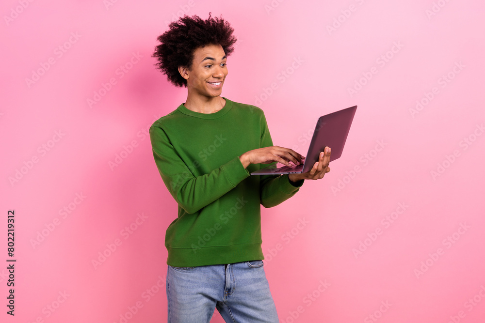 Photo of happy positive guy worker using netbook chatting isolated pastel color background Photo of happy positive guy worker using netbook chatting isolated pastel color background