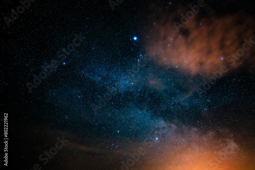 Milky way in the night sky. Long exposure with constellations. Cloud with sahara dust at the edge of the image. Weather phenomenon photographed in spring.