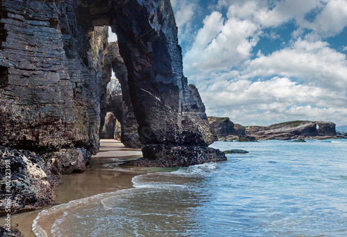 Natural rock arches on Cathedrals beach  in low tide (Cantabric coast, Lugo (Galicia), Spain). photo