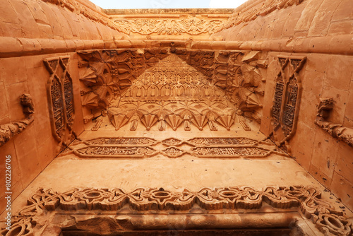 The elaborate patterns and details carved into the majestic ottoman gate, doorway seen from the second court inside the Ishak Pasha Palace, Sarayi, Dogubeyazit, Turkey photo