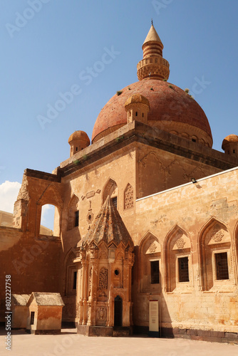 Ottoman tomb in front of a mosque with a red cupola, dome in the second court inside the Ishak Pasha Palace, Sarayi, Dogubeyazit, Turkey
