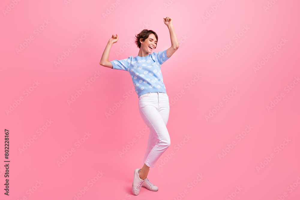 Full length photo of pretty carefree person raise arms good mood dancing partying isolated on pink color background