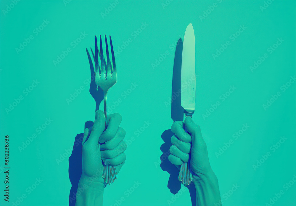 Fototapeta premium Two hands holding knife and fork in front of turquoise background, one hand with knife and fork, the other with knife and fork