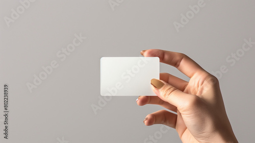 hand with golden nails holding empty card