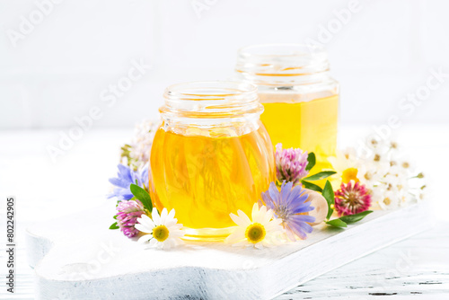jar with fresh flower honey and white background © cook_inspire