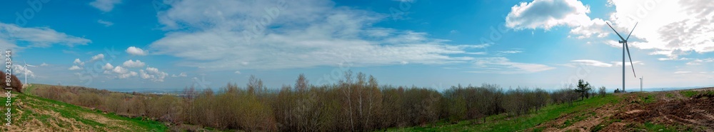 Wind turbine for alternative energy in mountain landscape with clear space background. The concept of clean energy, eco-energetics of the wind. Wind turbine for alternative energy in mountain landscape with clear space background. The concept of clean energy, eco-energetics of the wind.