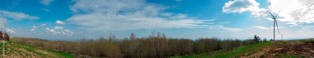 Wind turbine for alternative energy in mountain landscape with clear space background. The concept of clean energy, eco-energetics of the wind.