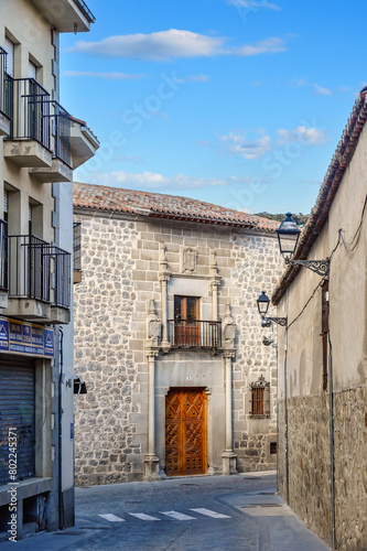 Narrow city street leading to Palacio de los Verdugos (1531) in Avila, Spain © TOimages