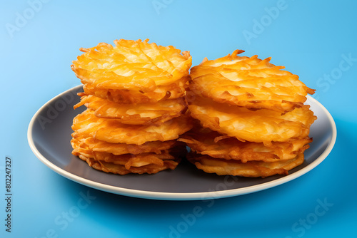 Set of golden brown and crispy hash browns stacked on a blue plate, isolated on a white or transparent background Generative AI,